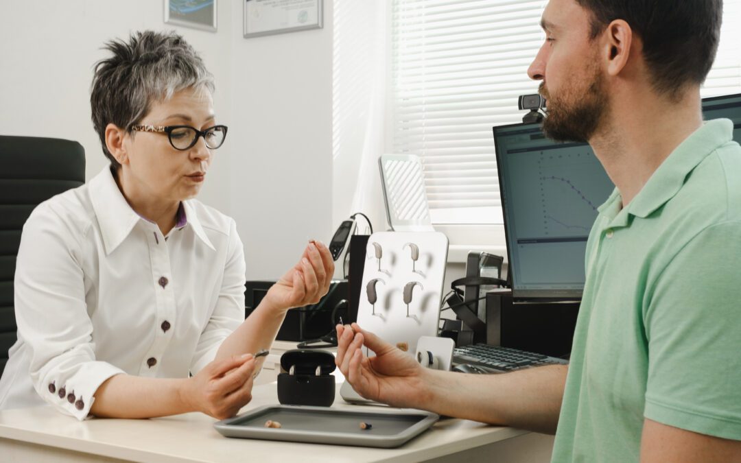 Audiologist in Wenatchee discussing hearing test results with patient | Horan and Fevold