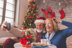 Couple enjoying a festive holiday gathering in Wenatchee, highlighting the importance of hearing health for the season.