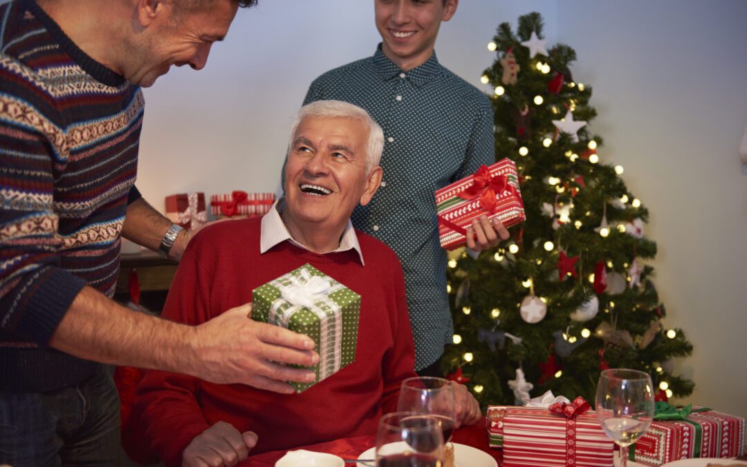 Family gathered around a festive holiday table in Wenatchee, emphasizing the importance of hearing health during noisy celebrations.