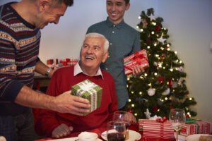 Family gathered around a festive holiday table in Wenatchee, emphasizing the importance of hearing health during noisy celebrations.